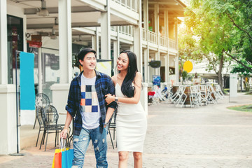 Asian Couple Enjoying Romance Spending shopping bags Fashion shopping street