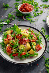 Fresh crispy Bacon, Potato salad with green vegetable on plate