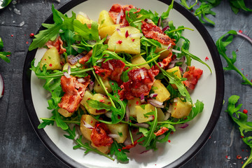 Fresh crispy Bacon, Potato salad with green vegetable on plate