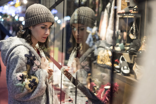 Woman Looking Shop Store Fashion Window In Winter Nights Looking For Some Clothes