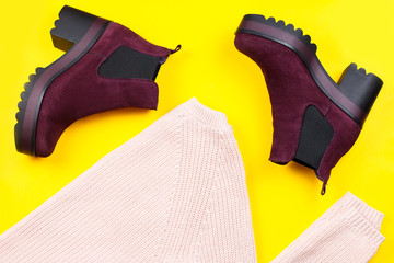 Fashion woman winter clothing and boots on bright background, flat lay