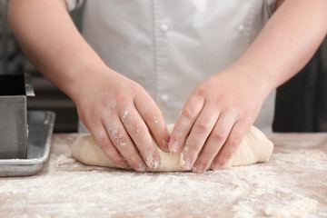 Man preparing bread on table in bakery