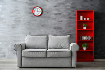 Stylish sofa in interior of living room