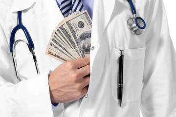 Doctor putting money in pocket on white background, closeup
