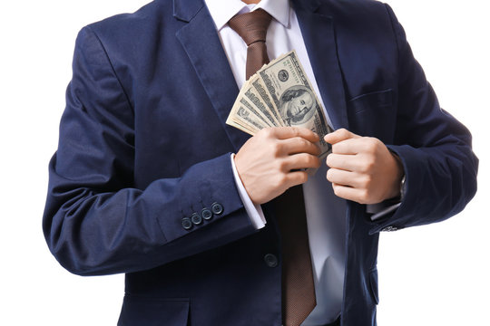 Man in formal suit putting money in pocket on white background, closeup