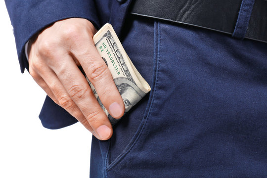 Man in formal suit putting money in pocket on white background, closeup