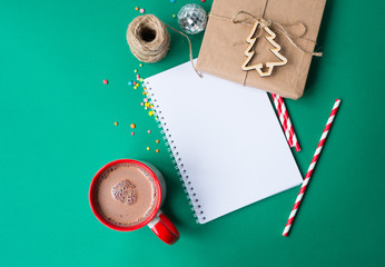 Christmas mug of hot chocolate and a New Year's gift with a notebook