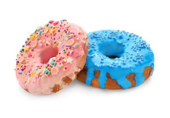 Colorful donuts with sprinkles on white background