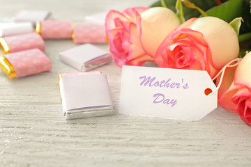 Flowers with card for Mother's day on table