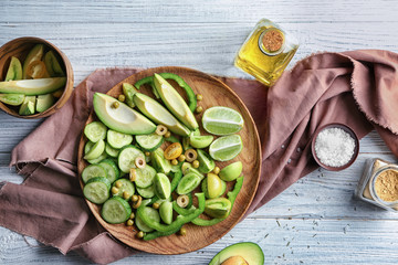 Plate with delicious vegetable salad on table