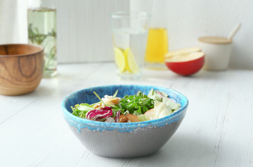 Bowl with delicious vegetable salad on table