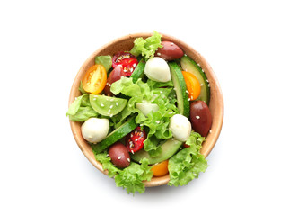 Bowl with delicious vegetable salad on white background, top view