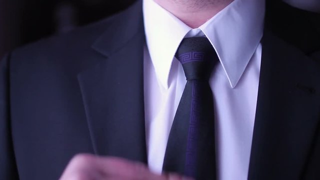 Businessmann corrects his necktie