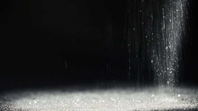silver sparkles falling on a black background
