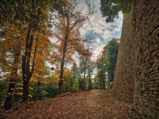 path near ancient walls in autumnal landscape