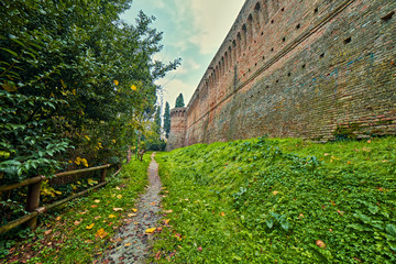 path near ancient walls in autumnal landscape