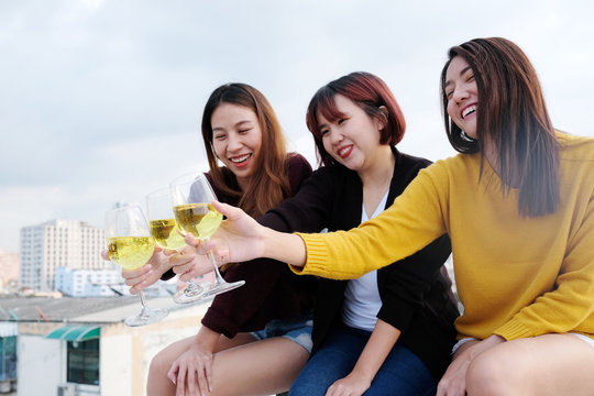 Group of young asia women drinking at rooptop new year, Christmas party, friends holiday celebration party concept