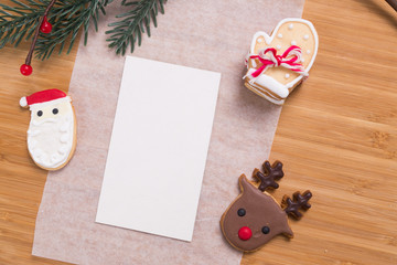 Note wite christmas homemade gingerbread cookies on wooden table