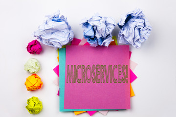 Writing text showing Microservices written on sticky note in office with screw paper balls. Business concept for Micro Services on the white isolated background.
