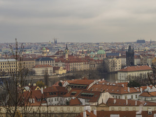 Fototapeta na wymiar Prague city panorama View on old town with teen tower, charles bridge, saint nicholas church and vltava river bank from old castle steps way to prague castle