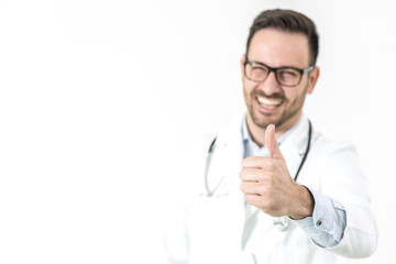 Handsome young doctor gesture with thumb up