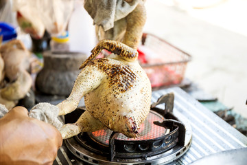 Plucking the chicken on the gas stove