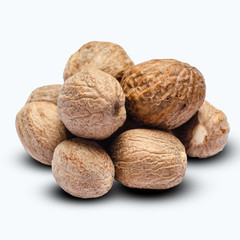 heap of nutmegs isolated on white background