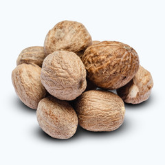 heap of nutmegs isolated on white background