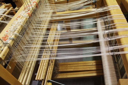 Loom makeing  cloths white and yellow handmake