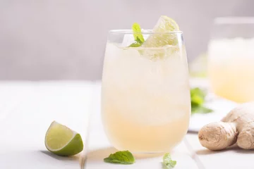 Tuinposter Fresh ginger beer with lime and ice © zakiroff