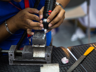 Industrial technician use handheld laser welding machine repair workpiece surface. Industrial manufacturing workshop
