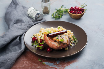 Roasted duck breast with couscous garnish and cherry sauce