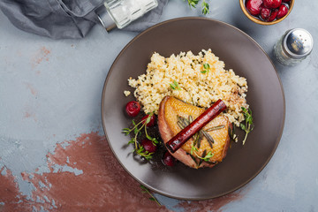Roasted duck breast with couscous garnish and cherry sauce