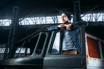 Fototapeta na wymiar Stalker pose on abandoned military vehicle