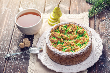 Homemade Christmas or New Year holiday pear pie decorated in a rustic style. Concept of festive desserts