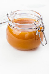 Homemade salted caramel sauce in a glass jar