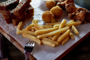 Hearty, fatty dish to the table. Cheese balls, fries and garlic croutons. Beer