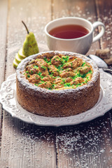 Homemade Christmas or New Year holiday pear pie decorated in a rustic style. Concept of festive desserts