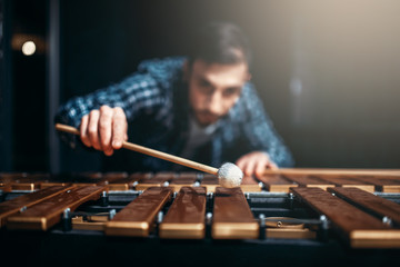 Xylophone player with sticks, musician in action