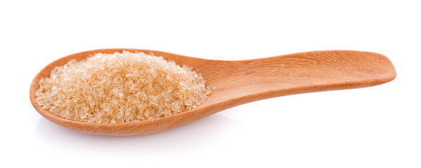 Brown sugar in wooden spoon on white background