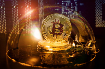 Bitcoin. Bitcoin in a soap bubble on video card background.