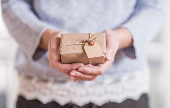 Young woman hands holding handmade gift box