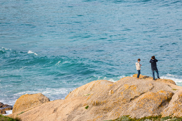 Father and son enjoying ocean view