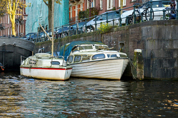 Fototapeta na wymiar Tourist boats in Amsterdam canal, October 12, 2017