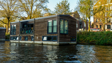 Fototapeta na wymiar Traditional Floating boat house in Amsterdam canals, the Netherlands, October 13, 2017