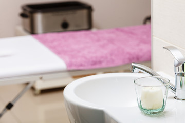 Focused sink with candle in beautician spa salon