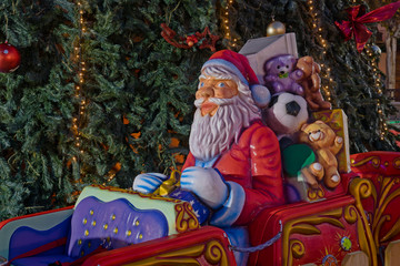 Santa Claus train handing out gifts. Christmas fair attraction. 