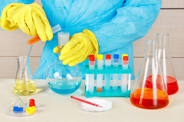 Researcher in rubber gloves is conducting chemical experiments in the laboratory