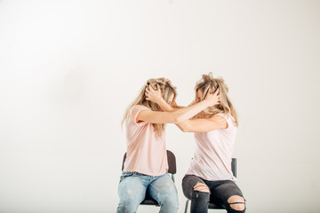 Two aggressive women arguing and shouting isolated on a white background.