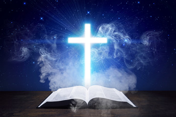 Glowing cross with Holy Bible and smoke coming from the Bible - 184165026